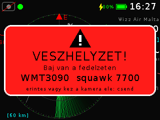Piros riasztás-felirat figyelmeztető háromszöggel: VÉSZHELYZET! Baj van a fedélzeten, squawk 7700